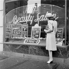 Black and White Photo of Woman Outside Beauty Shop
